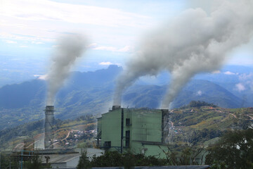 Fototapeta premium industrial smoke from chimney on blue sky