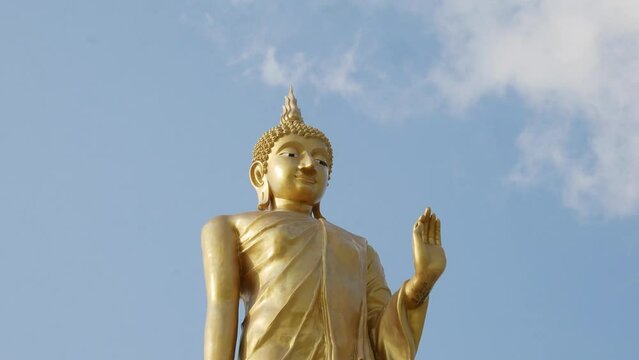 The standing buddha with blue sky in Thailand  ,Copy space 