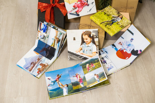 photo canvas and photo books near the christmas tree as a gift