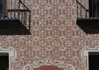 Detail of facade with sgraffito geometric decoration in the historic city center of Madrid. Spain.