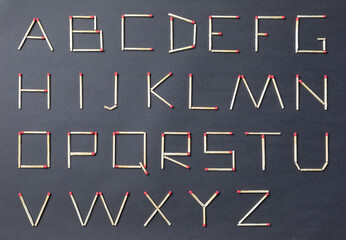 English alphabet made of matches on a black background. ABC.