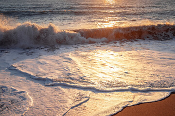 The sea wave. Sunset in the sea. The power of the elements.