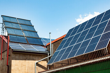 Fototapeta premium The roof of an energy efficient home with solar panels and solar water heaters.