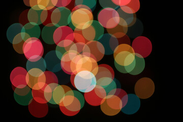 Defocused colorful lights on black background