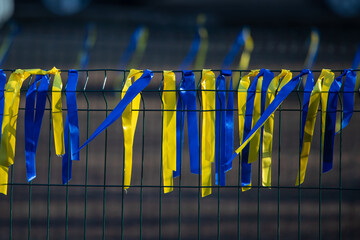 Ribbons on the fence, symbols of Ukraine