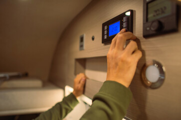 Men Adjusting Interior RV Camper Van Temperature - obrazy, fototapety, plakaty
