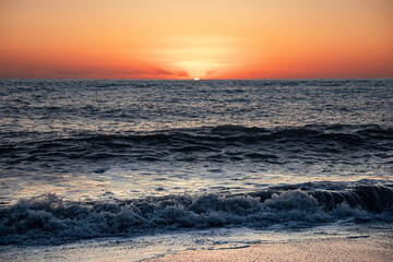 Fototapeta premium The sea wave. Sunset in the sea. The power of the elements. Landscape photography.