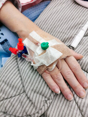 Patient hand with peripheral venous catheter on hospital after surgery.
