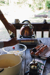making scrambled eggs outdoors while camping