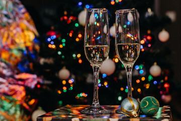 Two glasses of champagne on the background of festive Christmas lights. Glass for wine. bokeh. Christmas. New Year
