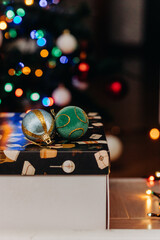 Two multi-colored shiny Christmas balls on the background of festive Christmas lights. Christmas decorations. bokeh. Christmas. New Year