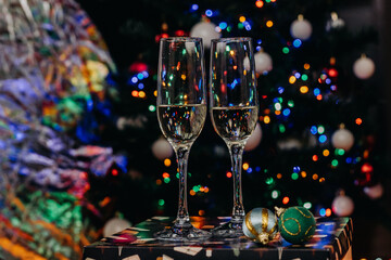 Two glasses of champagne on the background of festive Christmas lights. Glass for wine. bokeh. Christmas. New Year