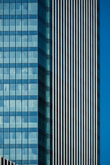 Fototapeta na wymiar Modern building facade. Vertical lines abstract facade in modern office building. New skyscraper.