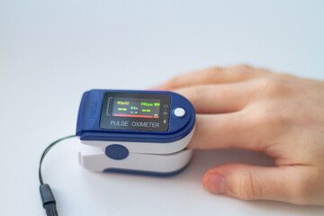 Pulse oximeter on the finger to measure the oxygen saturation of the blood, a medical device shows the amount of oxygen in the blood of a person
