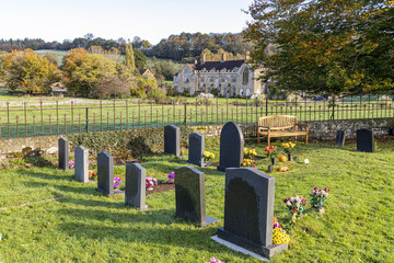 Naklejka premium Looking across the churchyard of St Mary the Virgin towards Flaxley Abbey in the Forest of Dean village of Flaxley, Gloucestershire, England UK