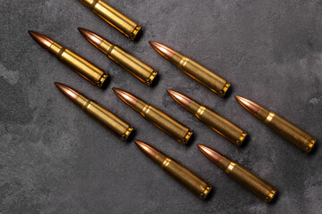 Bullets on gray background. Cartridges 7.62 caliber for Kalashnikov assault rifle. Top view, flat...