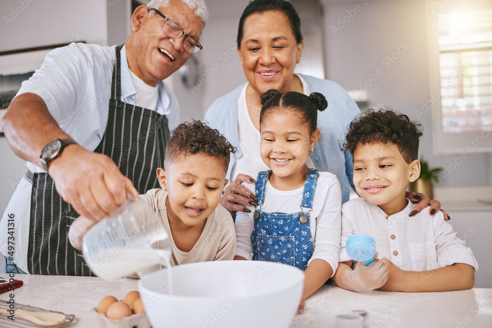 Poster Could I have a glass when youre done. Shot of a mature couple baking with their grandkids at home.