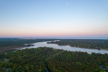 Downtown Mobile, Alabama skyline on the horizon from above Dog River 
