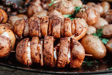 baked potatoes with lard on a wooden skewer