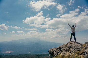 man standing on a mountain top