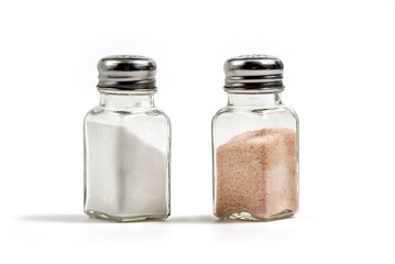 White sea salt and pink himalayan salt in salt shakers isolated on white background, 

clipping...
