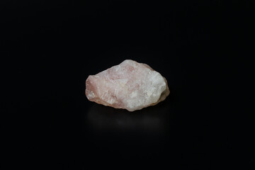 Quartz stone, Close-up of raw pink quartz stone isolated on black background. Precious raw mineral...