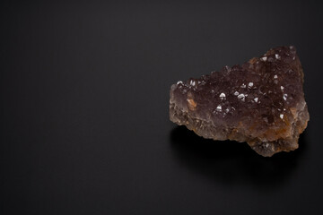 amethyst stone. Close-up of purple amethyst mineral rock on the black background. High angle view....