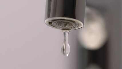 Mixer valve. Water drip drops from a water pipe. Closed faucet tap. Leak.