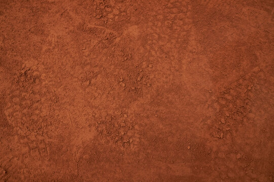 footprints on a clay tennis court close-up. Footprints on a clay tennis court. Footprints on a clay tennis court. Footprint on a tennis court bright color. Background for sport design, wallpaper.
