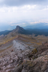 Obraz premium Young adventurous backpackers hiking on a mountain top