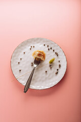 dumplings in a plate on a pink background