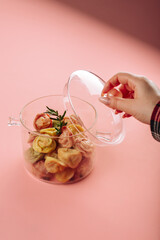 dumplings in a transparent saucepan on a pink background - 497349184