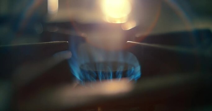 Gas-ring stove appliance turned on. Cooking in kitchen