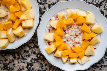 Useful breakfast. Oatmeal porridge with oranges and apples in a bowl. High quality photo