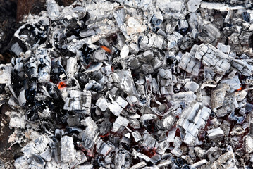 Burning coals on a bonfire close-up with a bonfire