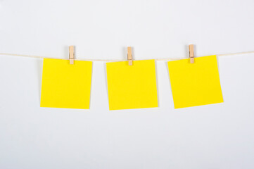 Tres postiks amarillos colgados para ejercicio, estrategia o trabajo en equipo, conceptos a tratar. - obrazy, fototapety, plakaty