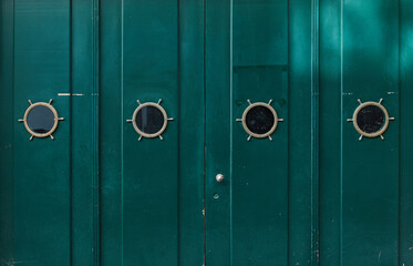 Fototapeta premium Green old wooden painted door with windows. Grunge texture for background.