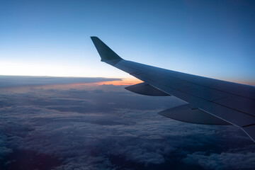 Fototapeta na wymiar airplane wing against sunset sky