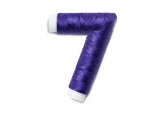 Number 7 from thread spools, isolated on white background. Alphabet concept.