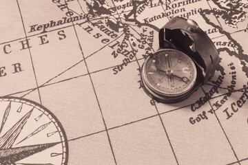 Fototapeta na wymiar Magnetic old compass on world vintage map.Travel, geography, navigation, tourism and exploration concept background.Macro shot, shallow focus.