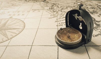 Magnetic old compass on world vintage  map.Travel, geography, navigation, tourism and exploration...