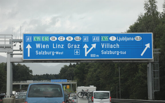 road sign in the highway with cars with directions to the city of Wien Linz  that towards the Austrian borders with other European nations
