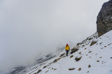 Man walking up snowy slope
