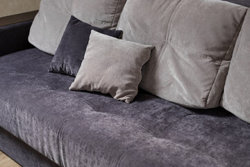 blue and grey pillows on couch in living room. home interior. close-up