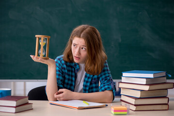 Young female student in time management concept