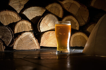 beer on the background of wooden logs in the sauna