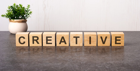 word creative made with wood building blocks