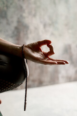 Meditation practice, hands puffed in om tonk mudra jet of incense smoke. 
Beads hanging on the...