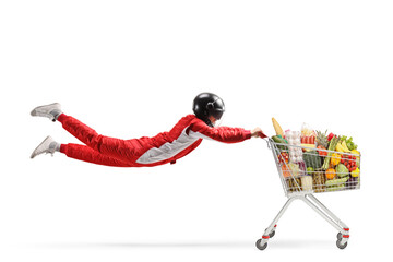 Car racer flying and holding a shopping cart with food