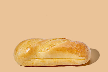 round bun on brown pastel background